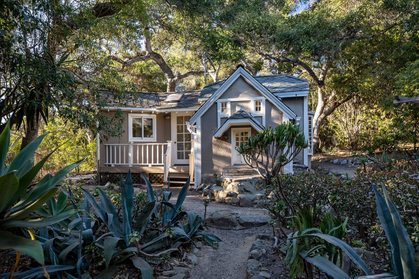 An adorable guest house surrounded by lush foliage